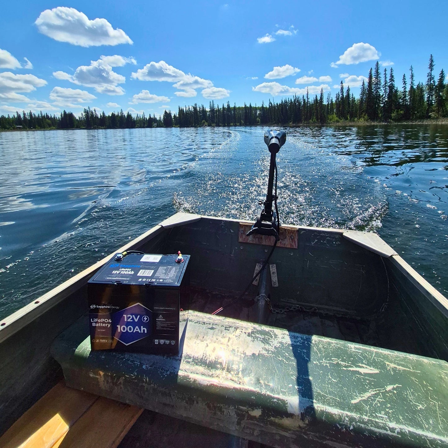 Electric trolling motor mounted on a metal boat, powered by a Sapphire lithium battery
