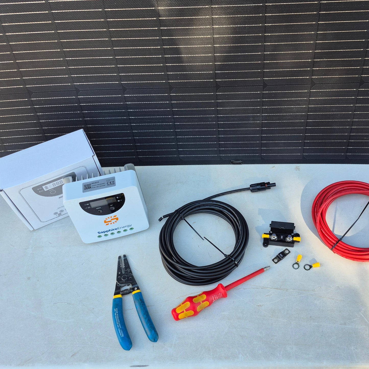 Solar panel installation kit with components on a flat surface