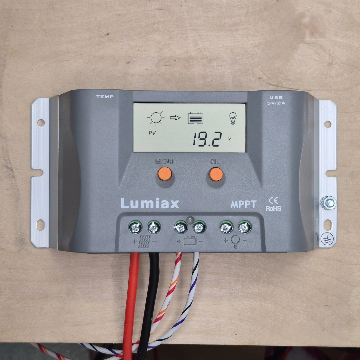 Lumiax 15A solar regulator on a wooden surface