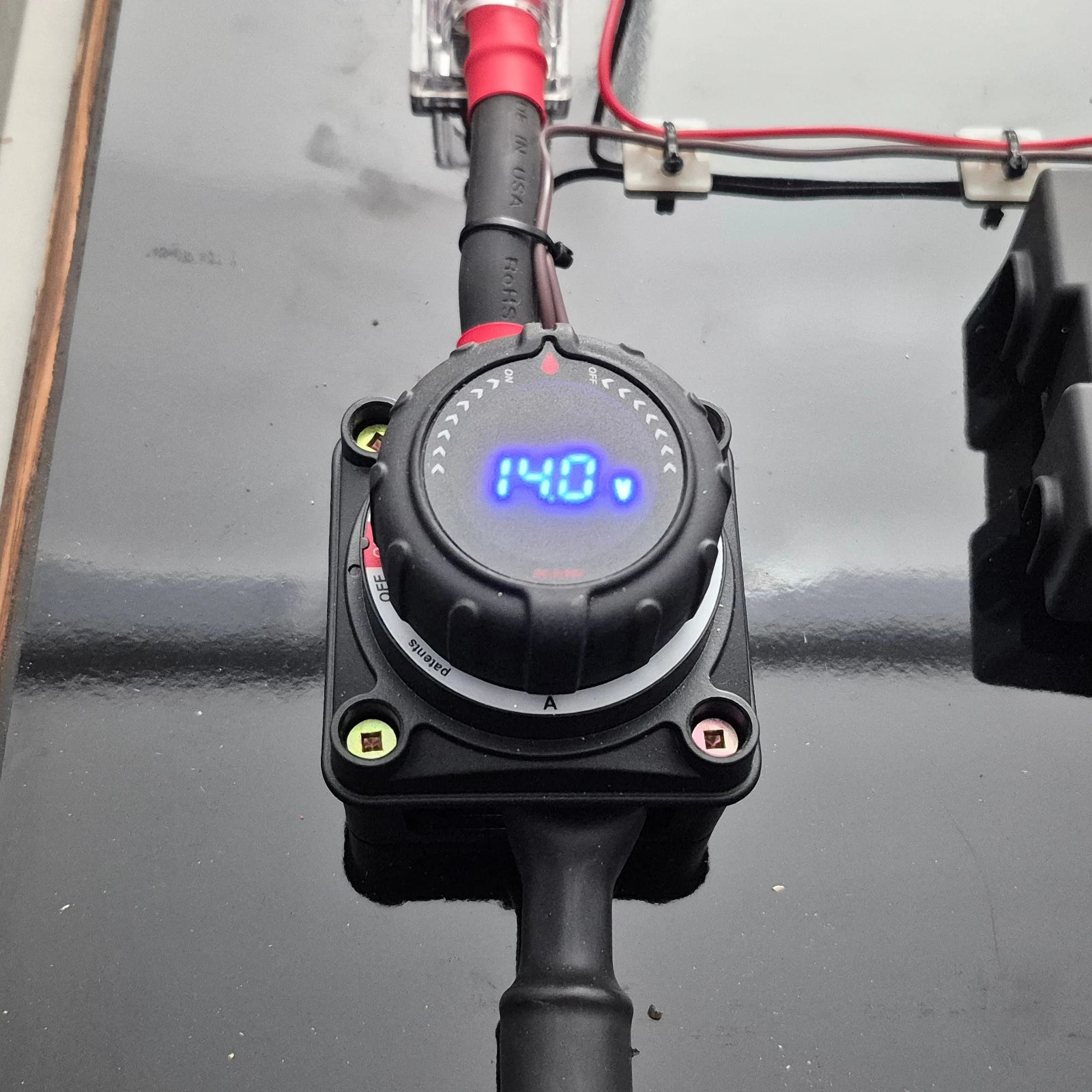 Battery Disconnect Switch with Digital voltage meter displaying 14.0 volts on a dark background