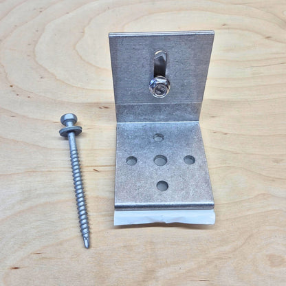 Kinetic Solar Universal L bracket with butyl seal on a wood background.  Shown with included screw and bolt hardware.