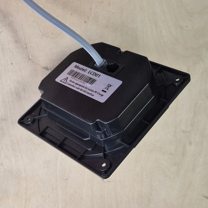 Black electronic component with a label on a wood surface