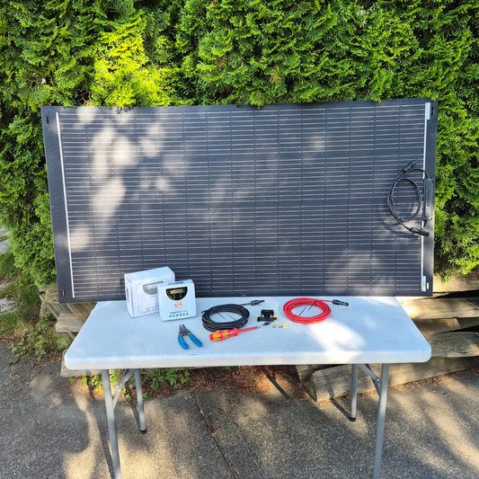 Solar panel on a table outdoors with tools and equipment.