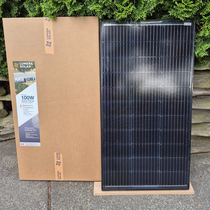 Lumera 100 Watt solar panel next to the cardboard package it comes in